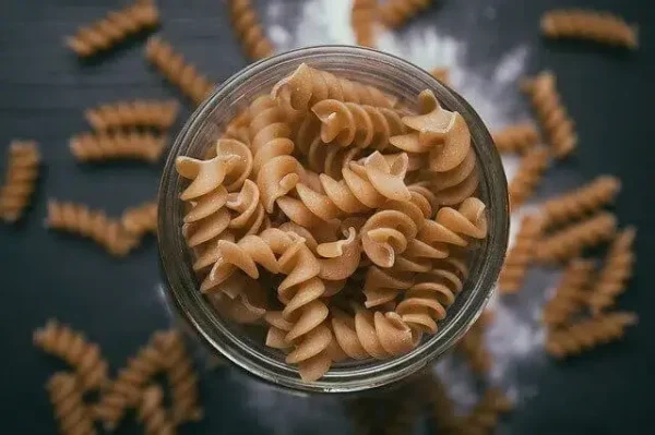 dried brown fusilli pasta in a glass Kilner jar