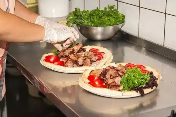 chef preparing two pizzas
